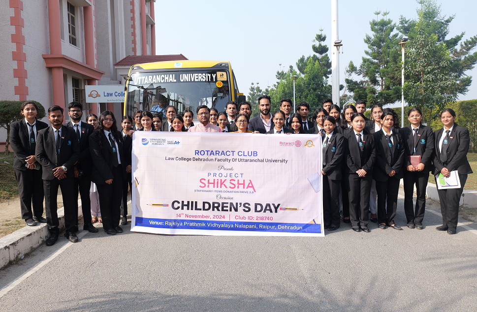 Uttaranchal University students with Project SHIKSHA banner for Children's Day