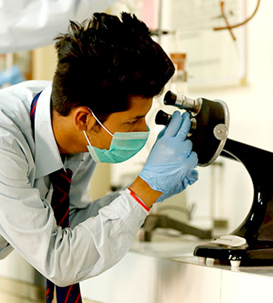 Student looking into a microscope