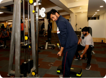 People exercising with equipment in a modern gym